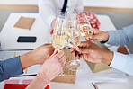 Closeup of group unknown business people sitting together and toasting with champagne glasses for Christmas in office. Team of colleagues celebrating successful year in festive holidays with alcohol