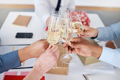 Buy stock photo Closeup of group unknown business people sitting together and toasting with champagne glasses for Christmas in office. Team of colleagues celebrating successful year in festive holidays with alcohol