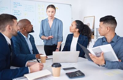 Buy stock photo Diverse group of business people talking in a meeting and using technology and paperwork in a boardroom. Team of professionals sitting together, brainstorming and planning a strategy in the office