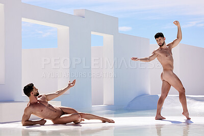 Two confident handsome young muscular mixed race men posing nude and showing their athletic, muscular body while flaunting their curvy shape in a square structure against a white background outside