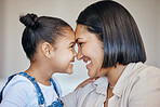 Adorable little girl and mom touching foreheads. Closeup of happy mother and daughter looking into each other's eyes. Mixed race family expressing love, enjoying tender moment together at home