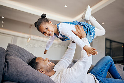 Happy young Caucasian father relax on sofa in living room play with small daughter