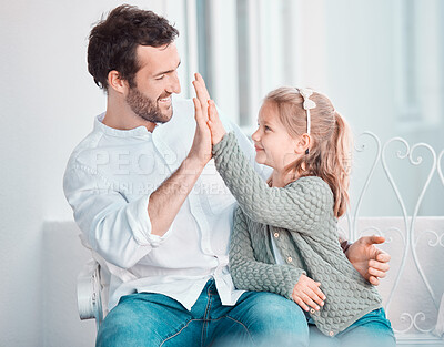 Buy stock photo Father, girl child and happy with high five, smile and hug with care, love and bonding on chair in home. Dad, kid and cheers with success, support and motivation at family house for celebration