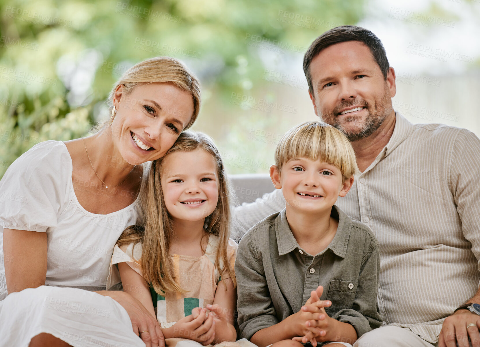 Buy stock photo Family, smile and relaxing on couch, portrait and bonding at home, fun and embrace for love. Parents and children, connection and security in relationship, happy and care or hug, living room and sofa