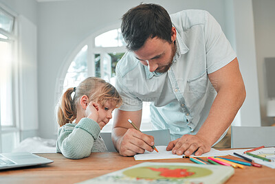 Buy stock photo Caucasian man writing in a book while helping his little daughter with homework and assignments. Little girl learning and studying through homeschool with dad. Parent teaching child at home