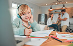 Portrait closeup of a cute happy caucasian little brunette girl wearing wireless headphones while holding a pencil and being creative by drawing in a book at home with her family in the background. Young girl listening to music with her wireless device wh
