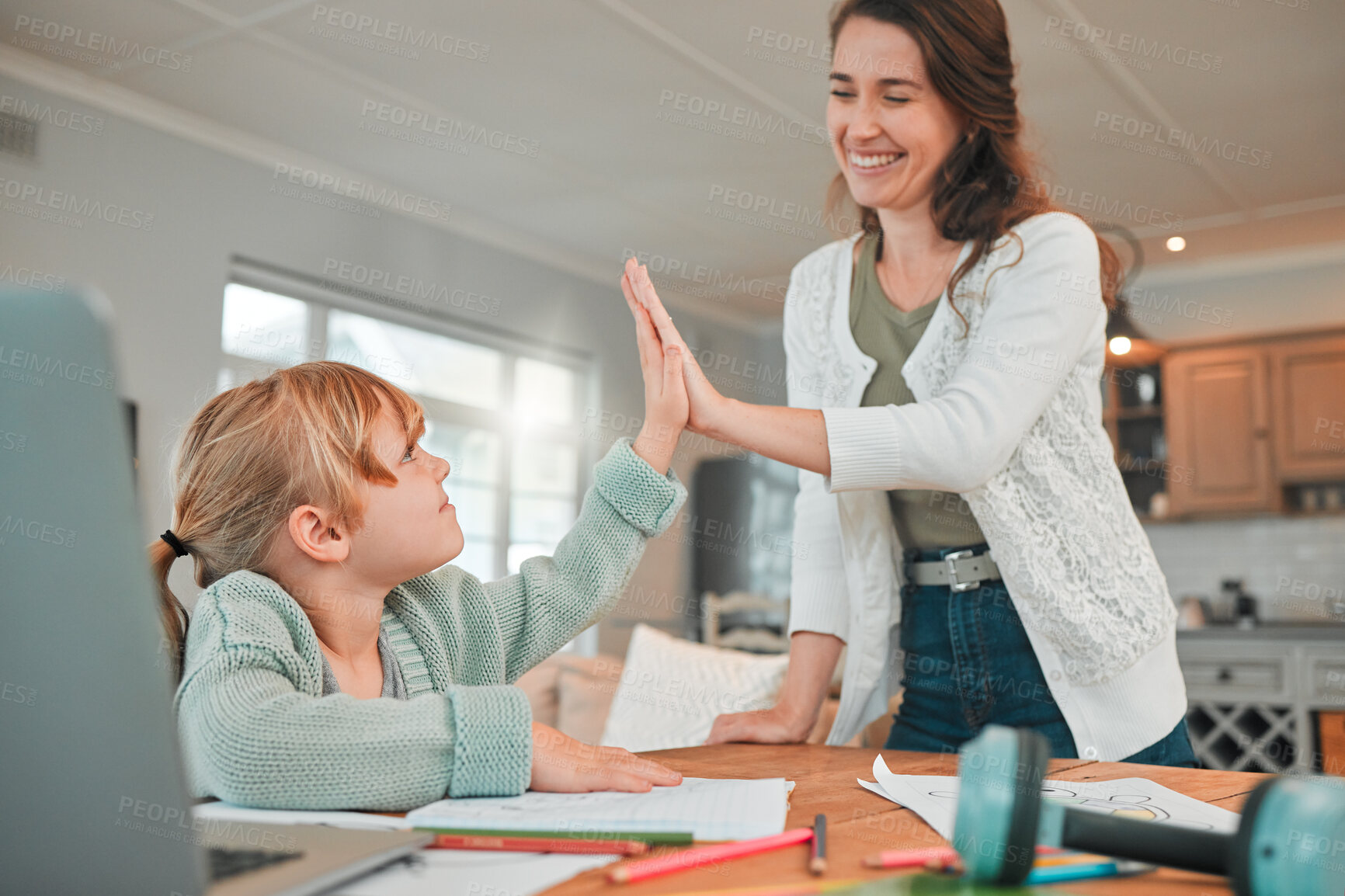 Buy stock photo Mom, girl and high five in home with learning, development and support with smile, documents or laptop. Education, mother and daughter with cheers for achievement, progress or growth in online course