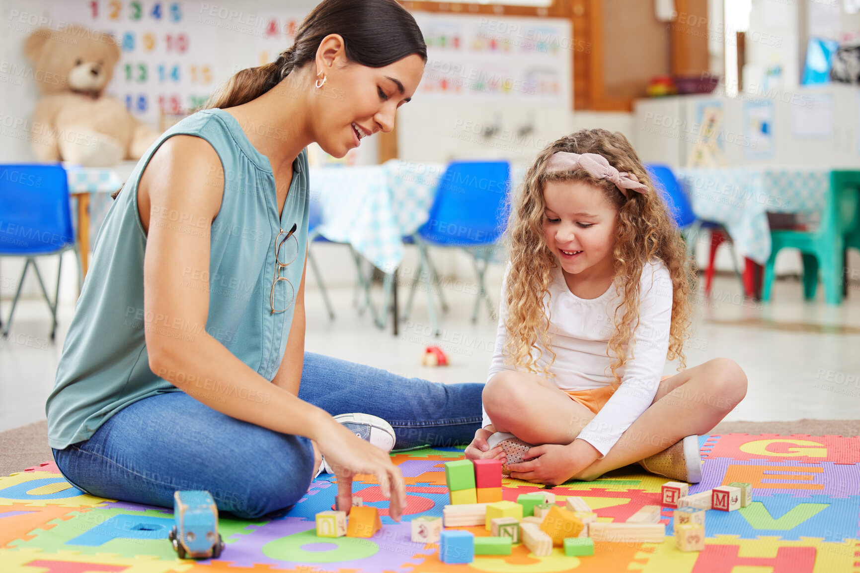 Buy stock photo Woman, kid and toys for playing in classroom for learning, fun or development. Female teacher, little girl and colorful blocks for education, growth or milestone in childhood with exciting activity
