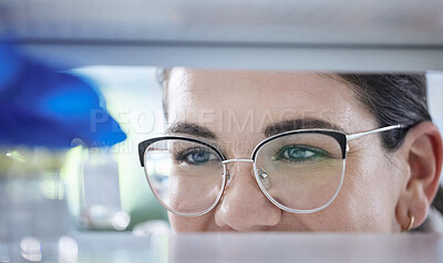 Buy stock photo Science, search and the eyes of a woman in a lab for research, innovation or medical storage. Healthcare, medical and pharmaceuticals with a happy scientist in a laboratory for cure development