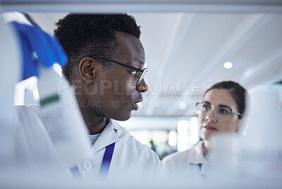 Buy stock photo People, scientist or team checking inventory in lab for experiment, sample bottle or chemical. Young man and woman in teamwork together for science research, stock check or product test at laboratory