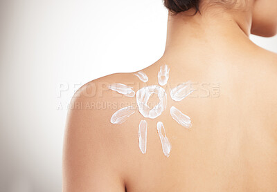 Buy stock photo Back of a beautiful woman showing her applying cream on her shoulder posing against a grey copyspace studio background. Skincare is important. Protection from the sun