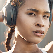 Closeup portrait of one fit young hispanic woman listening to music ...