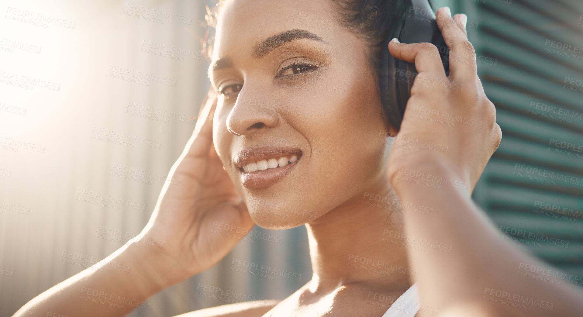 Buy stock photo Face, portrait of a woman and with headphones for motivation for training. Lens flare and happy smile, workout or exercise of female athlete listening to fitness music for health, sport or wellness
