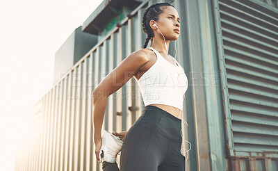 Buy stock photo Fitness, sports and woman stretching legs in city or shipping dock listening to music, audio and track. Sports, healthy body and female person outdoors for exercise, training and warm up for running