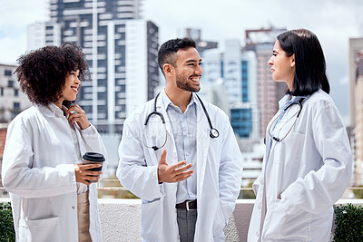 Buy stock photo Happy, doctors and talking of healthcare on coffee break, outdoor and relax at hospital, clinic or colleagues on rooftop. Surgeon, smile and enjoy drink on balcony with staff and work in medicine 