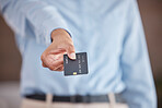 Close up of female's hands holding out credit card. Business woman showing card for payment or advertising mockup bank card with online service. 