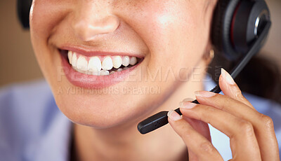 Closeup of smiling mixed race call centre agent talking to customers with a headset. Hispanic businesswoman answering calls, helping clients from an office. Headshot of customer service representative