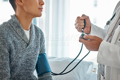 Closeup of caucasian doctor in white uniform talking with male patient in private clinic while using a stethoscope. Male GP or therapist consult man at meeting in hospital. Healthcare checkup.