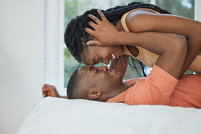 Buy stock photo Happy couple, affection and in the bedroom with love, care and intimacy together. Smile, marriage and an African man and woman with happiness, embrace and passion on a bed of a house in the morning