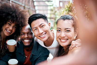 Portrait of cheerful young woman taking selfie with her friends while out for coffee together. Group of diverse friends having fun while spending time together or on enjoying a double date