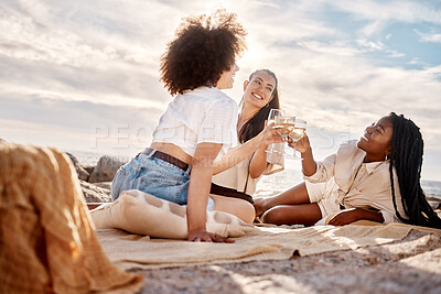 Buy stock photo Three young mixed race female friends hanging out and having wine at the beach. Hispanic women having a glass on wine outdoors