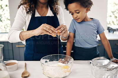 Buy stock photo Closeup of female hands cracking a egg into a bowl while baking at home with her son. Woman adding ingredients to a glass bowl on the counter at home while baking with her child 