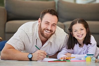 Portrait of father and daughter doing homework together drawing pictures and having fun. Dad teaching daughter while using book and colouring pencils