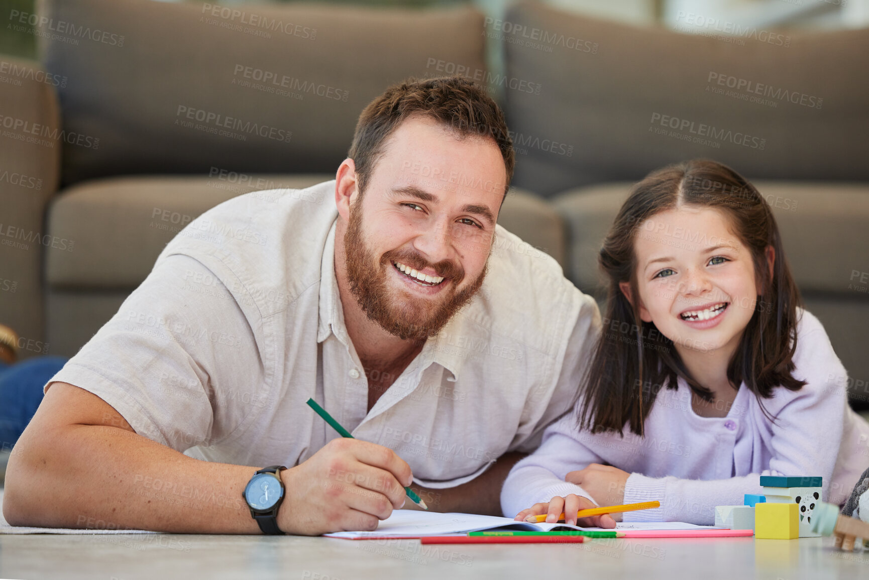 Buy stock photo Father and daughter doing homework together drawing pictures and having fun. Dad teaching daughter while using book and colouring pencils