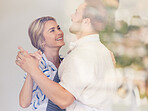 Cute couple dancing at home.  Smiling husband and wife celebrating anniversary, enjoying tender moment. Lovers having fun
