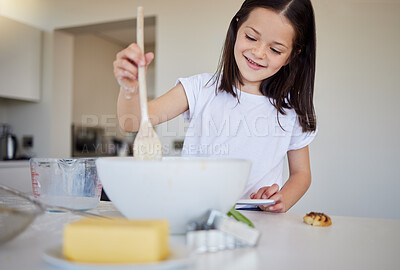 Buy stock photo Happy little girl baking at home. Smart girl mixing ingredients to prepare dough in the kitchen. Helpful child in the kitchen
