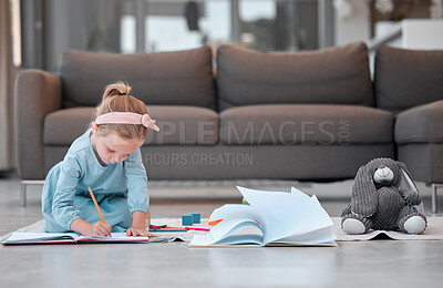 Buy stock photo Adorable little girl sitting on the floor and writing or drawing with pencil at home. Small caucasian girl doing homework or  being creative