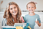 Little caucasian girl helping her mother with household chores at home. Happy mom and daughter excited to do spring cleaning together. Kid learning to be responsible by doing tasks
