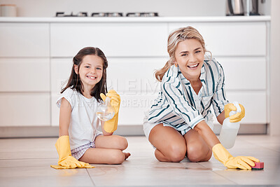 Buy stock photo Portrait of a smiling young caucasian woman kneeling and scrubbing the floor with her daughter. Adorable little girl helping her mother with housework and chores. Teaching children healthy habits