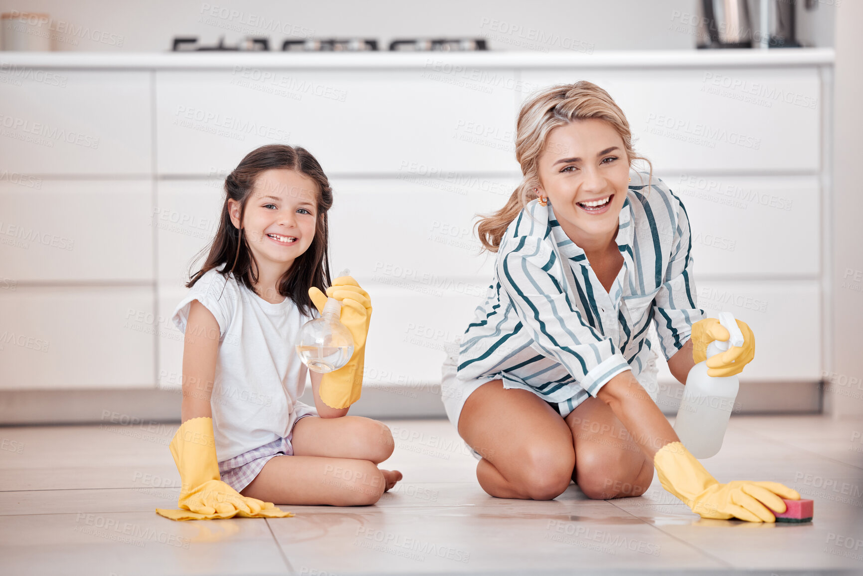Buy stock photo Portrait of a smiling young caucasian woman kneeling and scrubbing the floor with her daughter. Adorable little girl helping her mother with housework and chores. Teaching children healthy habits