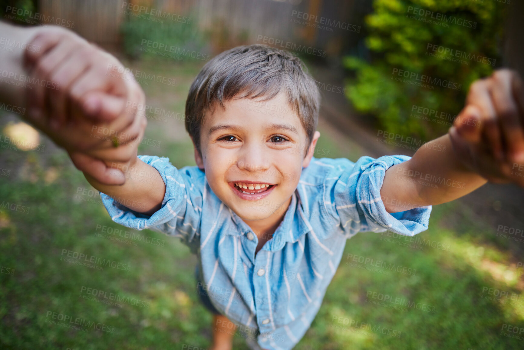 Buy stock photo The moment of lifting the son up holding his hands by mom and dad while outside in the backyard. Young happy boy having fun and smiling while being lifted by two hands on a sunny day
