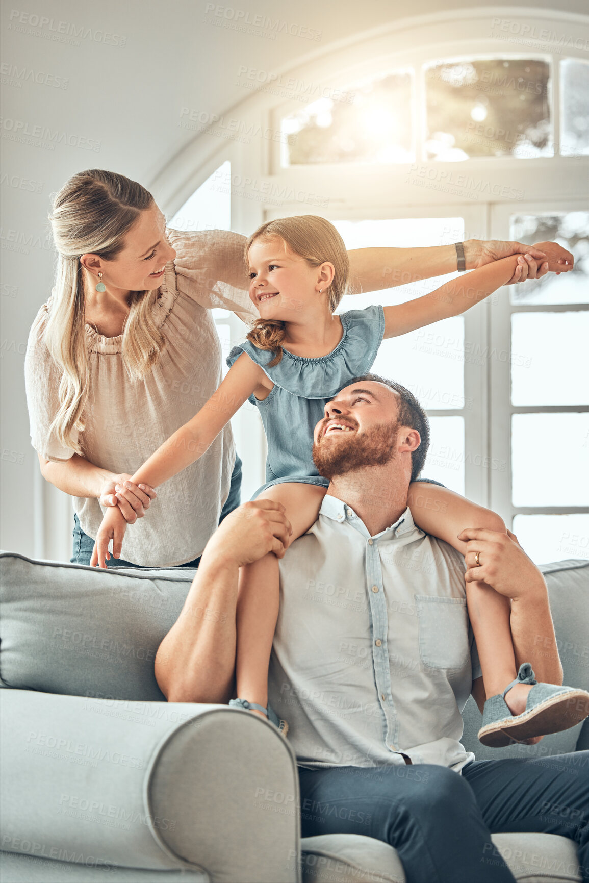 Buy stock photo Mom, dad and child on sofa with flying game, piggy back and playful fun in living room for happy family. Mother, father and kid playing airplane games on couch with smile, happiness and love in home.
