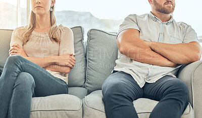 Buy stock photo Angry caucasian married couple sitting on couch arms folded to avoid fight. Couple in conflict distanced on sofa. Frustrated couple sitting apart on a couch. Unhappy couple in therapy on sofa together