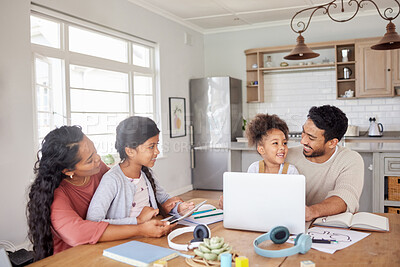 Buy stock photo Mixed race family using information technology at home. Two little girls doing homework in the kitchen with help from their mother and father. Parents and children working on school work together