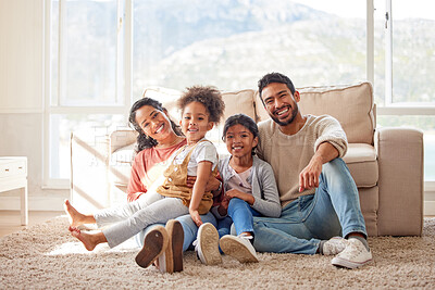 Buy stock photo Happy, love and portrait of a family in the living room sitting on the carpet in their house. Happiness, smile and children relaxing on the floor with their parents in the lounge of a modern home.