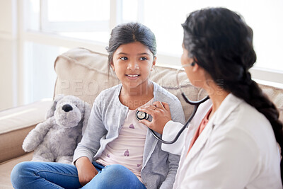 Buy stock photo Doctor examining a little girl with stethoscope. Female paediatrician listening to child's heartbeat during home visit or checkup at clinic. Caring woman in healthcare sector working with patient 
