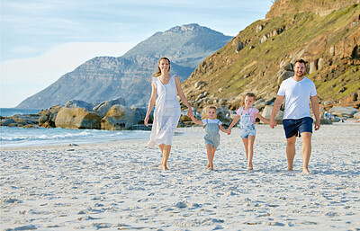 Buy stock photo Happy family walking  the beach. Smiling young parents with children having fun on vacation. Little boy and girl enjoying summer with mother and father