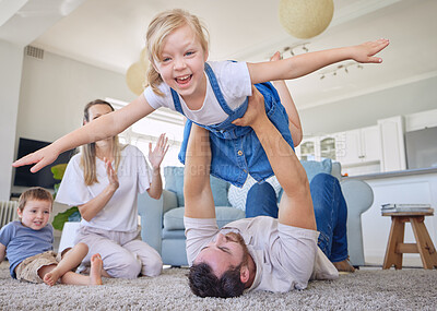 Buy stock photo Happy family, parents and children on carpet in living room playing, bonding and airplane game time. Home, love and playful energy, mom and dad with kids on floor, laughing and relax with happiness.