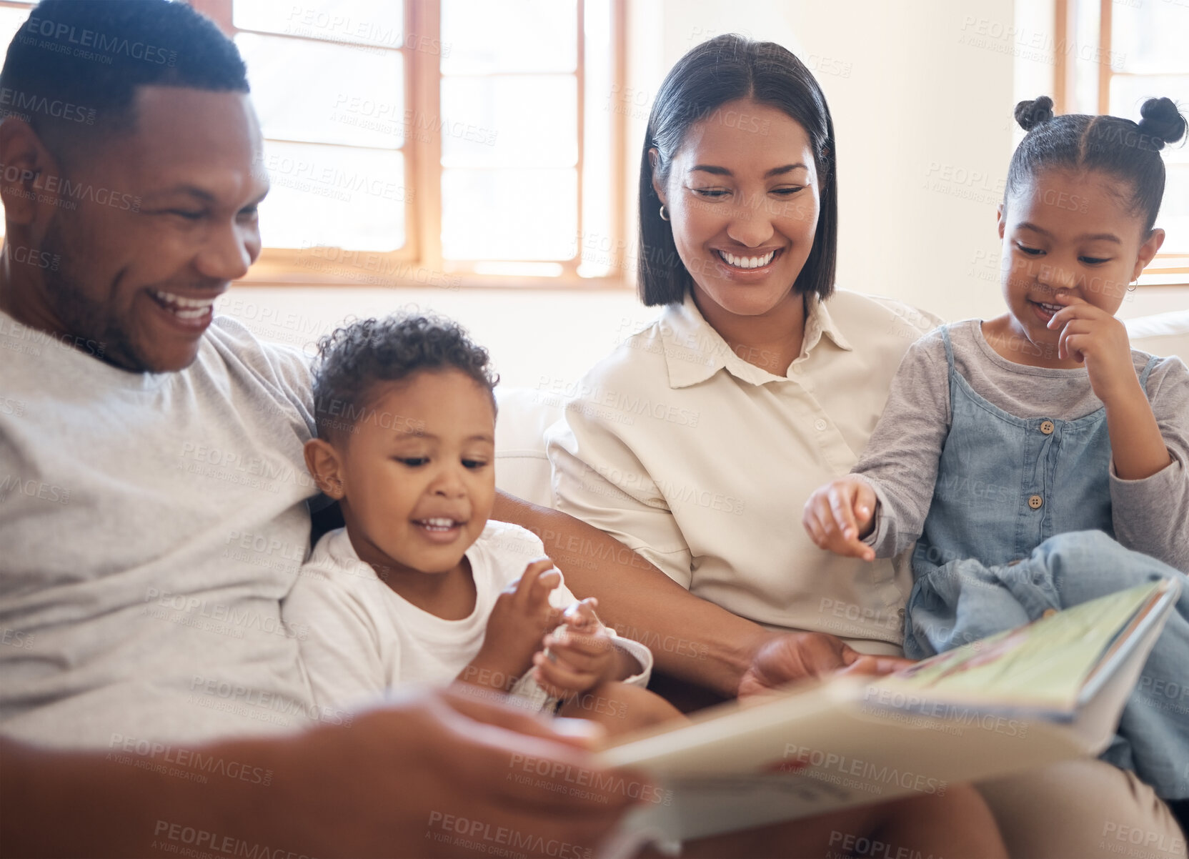 Buy stock photo Funny family, reading book and learning in home living room, bonding or care. Storytelling, education and happy parents, children and multiracial father, mom and teaching, studying and laugh together