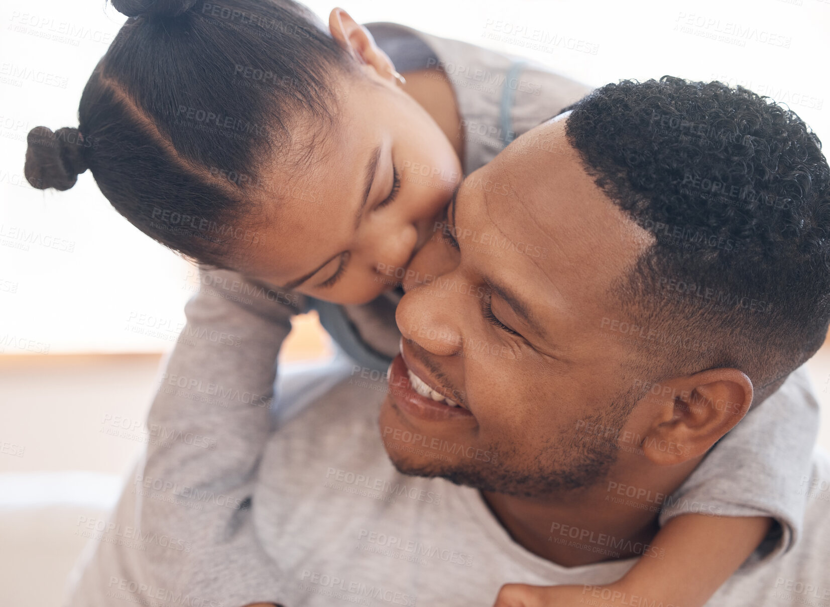 Buy stock photo Closeup adorable little girl smiling and hugging her single father inside at home. Cute mixed race child enjoying weekend free time with single parent. Hispanic man bonding and holding his daughter 