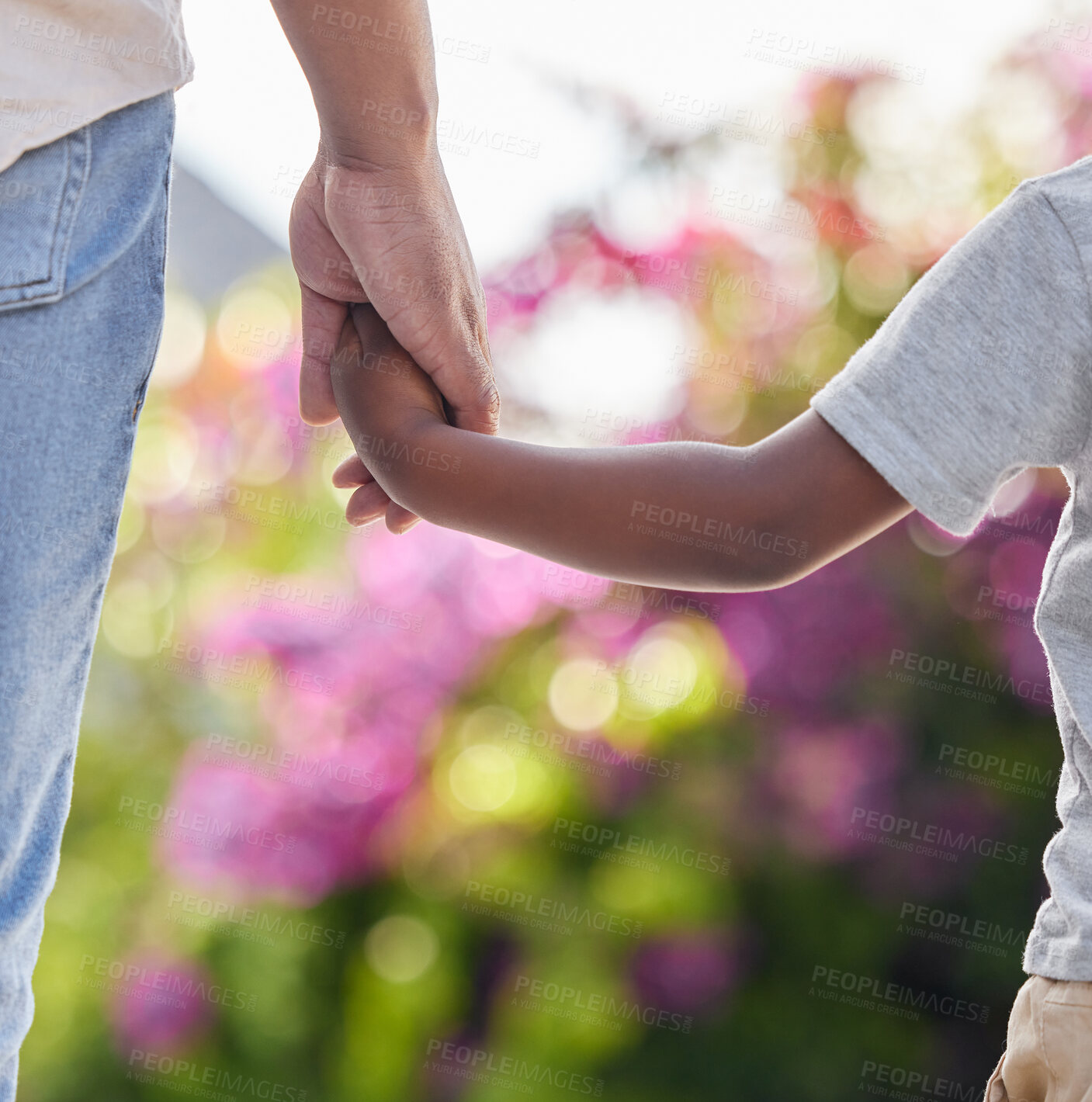 Buy stock photo Closeup, father and son holding hands, outdoor and guidance with support, affection and loving. Zoom, male parent and boy with dad, outside and childhood development, park and bonding with love