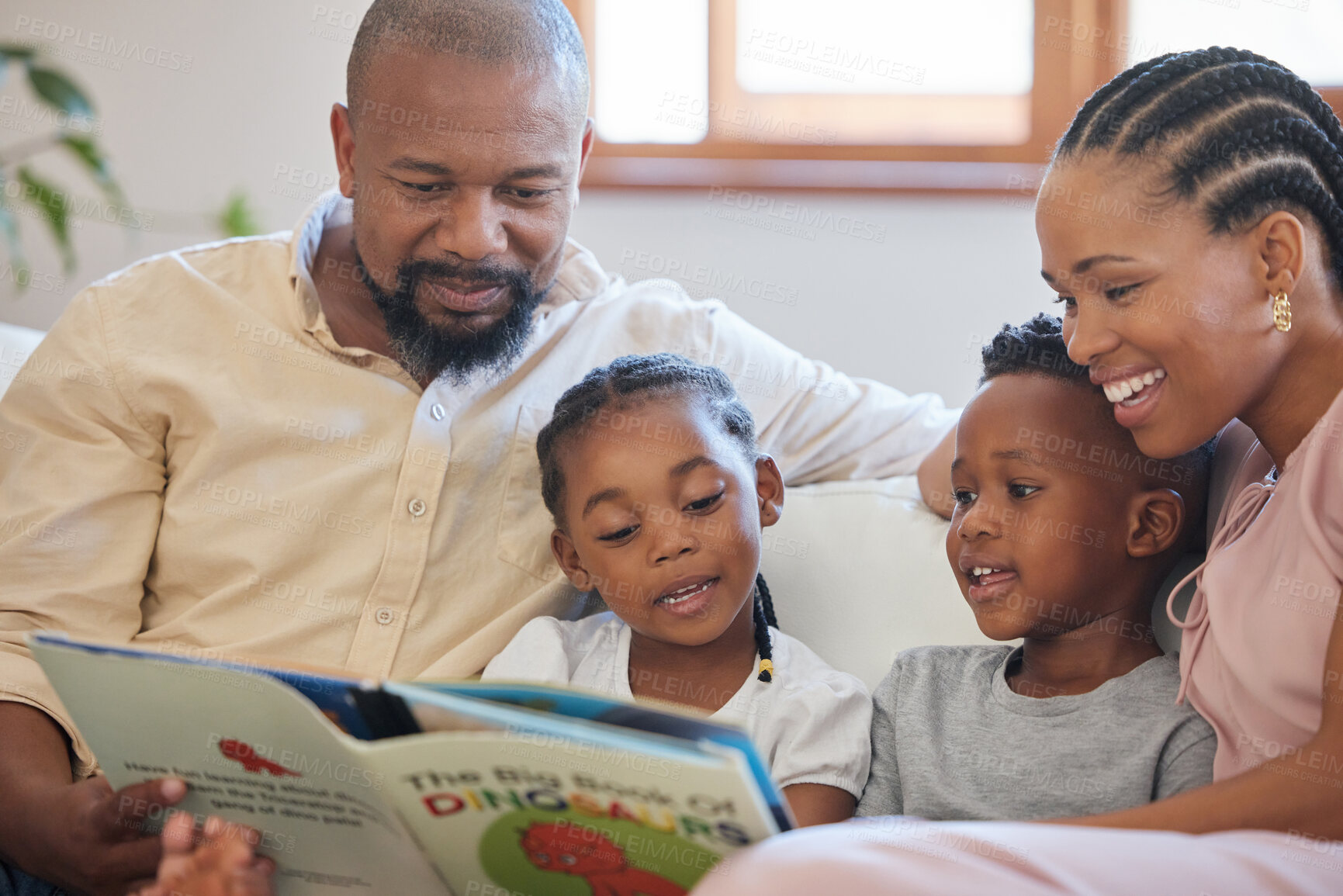 Buy stock photo Reading, African family and book in living room on weekend to relax, storytelling and parents on couch. Black man, woman and kids on sofa for care, fantasy and trust or bond together with love 