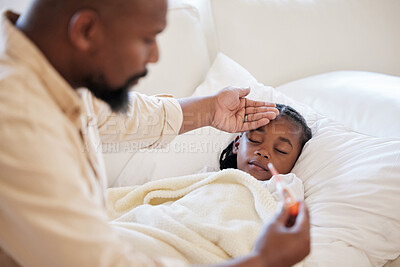African american father checking his sick daughters temperature while taking care of her at home. Little girl sleeping in bed while her dad checks her fever. Man feeling his daughters forehead