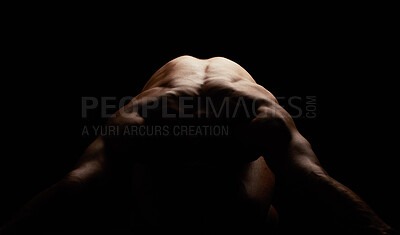 Nude man posing while isolated against black background in a studio. Strong and muscular unknown athlete showing back and naked body in creative, artistic studio. Sexy hot model feeling sensual, free