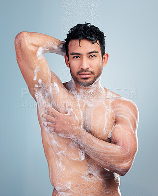 Buy stock photo Portrait of man lathering his body. Young man applying soap to his body in the shower. Hispanic man cleaning his body. Man rubbing soap foam on his body. Mutliracial man bodycare, skincare routine