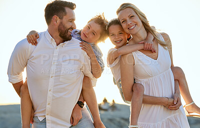 Buy stock photo Portrait of a happy caucasian couple carrying their kids on their back at the beach. Smiling mother and father piggyback their son and daughter on a sunny day